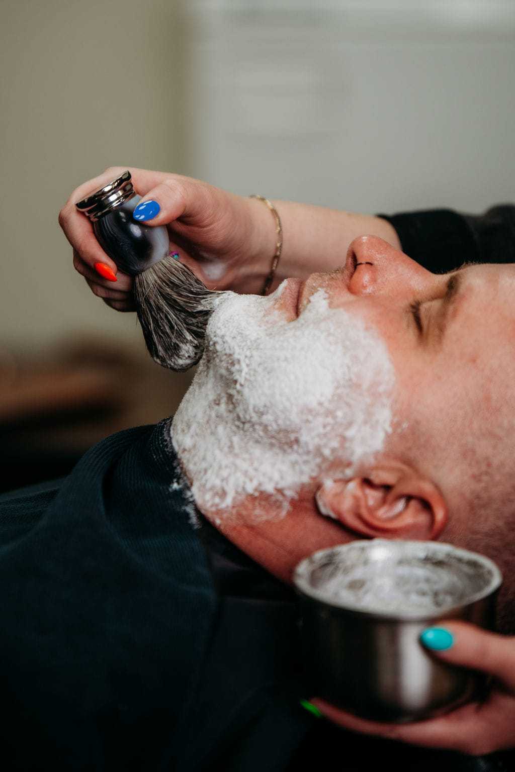 Man receiving a straight razor shave